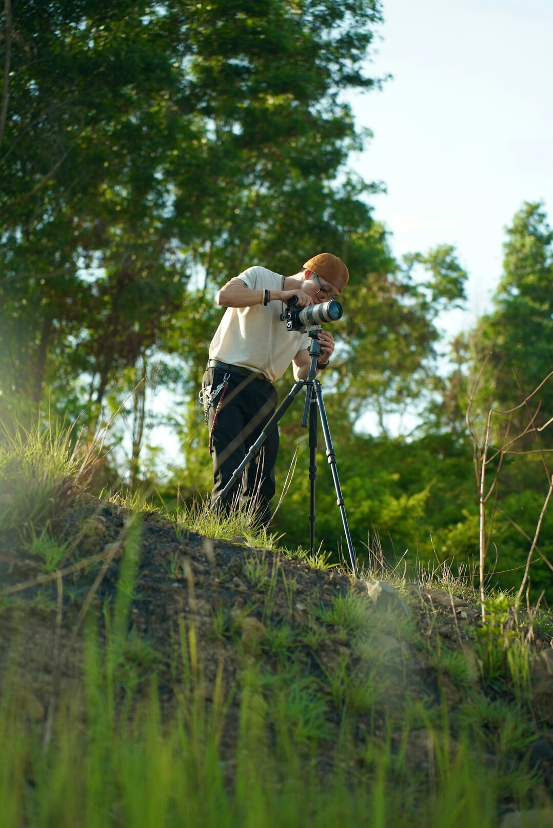 Camera operator preparing a short video sequence on a tripod